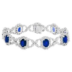 Gorgeous tennis bracelet set with 9 Blue Sapphires surrounded by brilliant cut round diamonds. These Blue Sapphires are linked with flower shape Marquise diamonds. Total weight of the Blue Sapphires is 11.47 carats; Total weight of the round diamonds is 1.36 carats and Marquise diamonds weigh is 2.60 Carat. Made with 14k white gold. All diamonds are GH color SI1 Clarity. Available in Ruby and Emerald as well. Style available in different price ranges. Prices are based on your selection. Please c Luxury Blue Tennis Bracelet For Formal Events, Oval Diamond Bracelet With 17 Jewels, Oval Diamond Bracelet With Gemstones, Exquisite Oval Diamond Bracelet, Exquisite Oval Diamond Bracelet For Formal Occasions, Dazzling Oval Diamond Bracelet, Hand-set Oval Diamond Bracelet, Formal Sapphire Diamond Bracelet With Accents, Oval Diamond Cut Cubic Zirconia Bracelets