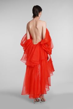 the back of a woman wearing an orange dress