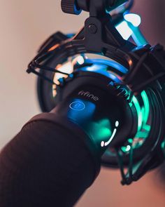 a close up view of the headphones on a bike with green and blue lights