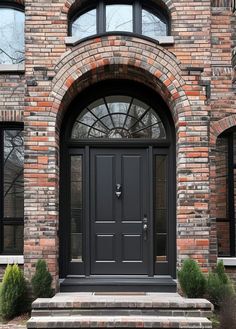 a black front door on a brick building