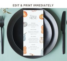 a black plate with a menu on it next to utensils and a fork