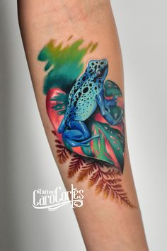 a colorful frog tattoo on the arm