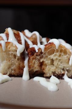 a pastry with white icing sitting on top of a plate