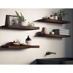 three wooden shelves in the bathroom with towels, soap and other items on top of them