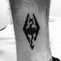 a black and white photo of a man's foot with a tattoo on it