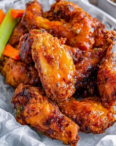 chicken wings with sauce and carrots on the side