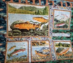 a quilted wall hanging with pictures of fish on it's sides and trees in the background