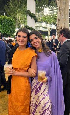 two women standing next to each other at an event