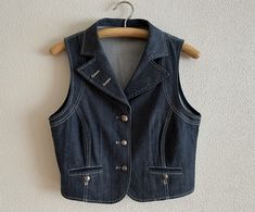 "Women's Vest Denim Vest Jeans Vest Fitted Womens Waistcoat Metal Buttons Vests Country Western Boho Sleeveless Denim Jacket Large Size Label size: 40/42 EUR, 14 UK Measurements (lying flat): Length(back): 18.5\"/ 47 cm Pit to pit: 19\"/ 48 cm Waist: 17 1/4\"/ 44 cm Please check measurements to insure a proper fit. Remember to allow yourself some extra room for movement. You can compare these with something from your closet that fits you well. Please convo me if you need additional measurements. Spring Dark Wash Vest With Buttons, Vintage Denim Vest For Workwear In Spring, Sleeveless Denim Jacket, Vest Jeans, Jeans Vest, Vest Denim, Womens Waistcoat, Jean Vest, Western Boho