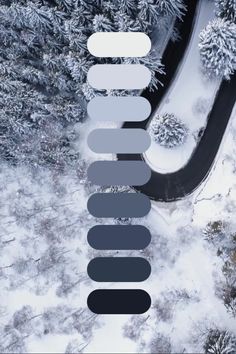 an aerial view of snow covered trees and road