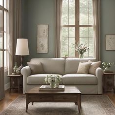 a living room scene with focus on the couch and coffee table in front of the window