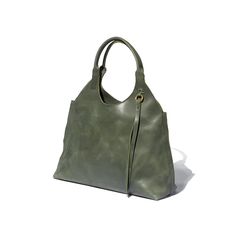 A green tote bag with a 1970's silhouette handcrafted from sustainable leather and lined with 100% Ethiopian cotton. Vintage Hobo Bag With Detachable Handle For Everyday, Vintage Hobo Bag With Gold-tone Hardware, Rectangular Hobo Bag With Brass Hardware For Travel, Elegant Rectangular Hobo Bag With Brass Hardware, Everyday Rectangular Hobo Bag With Brass Hardware, Rectangular Hobo Bag With Brass Hardware For Everyday, Elegant Hobo Bag With Brass Hardware For Daily Use, Chic Hobo Bag With Brass Hardware For Everyday Use, Bohemian Shoulder Bag With Round Handle