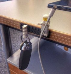 a lego keychain attached to a computer desk