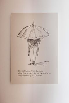 an open book with a drawing of a person holding an umbrella on it's back