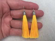 "Chic yellow tassel earrings! They would add a pop of color to any outfit for any occasion. Dress them up or down. They are timeless and versatile. They are lightweight, fun and unique! The tassels measure 2 1/8\" long by 1/4\" wide. They hang from simple silver ear wire hooks. Overall drop length is about 2 1/4\". Metal is allergy free plated silver. These are my latest creation! I have them available in many colors! Find them all under the category tassel earrings in my shop. Thanks for stoppi Yellow Dangle Tassel Earrings Gift, Yellow Tassel Earrings As Gift, Yellow Statement Earrings, Yellow Tassel Earrings, Acorn Jewelry, Green Tassel Earrings, Silver Statement Earrings, Silver Flower Earrings, Yellow Jewelry