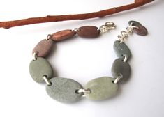 Beautiful bracelet made of misty green and brown Mediterranean beach stones... Very comfortable, very sturdy and full of spirit! Great gift idea for nature lovers. All metal parts are sterling plated. The closure is lobster clasp. Max. adjustable length is: 19 cm. ★ Ready to ship via Registered Express Airmail. You can UPGRADE to UPS (delivery in 3-4 days) if you like faster delivery. ★ For more yummy pebble, river rock jewelry making supplies StoneAlone.etsy.com 5367 Beach Pebble Jewelry, Tumbled Rock Jewelry, Rock Jewelry Diy, Elle Argent, Mediterranean Beach, Pebble Jewelry, Yw Activities, Eco Jewelry, Rock Jewelry