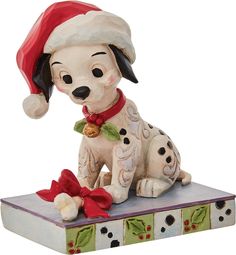 a ceramic figurine of a dog wearing a santa hat