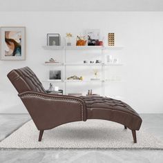 a living room with white walls and a brown leather reclining chair in the middle