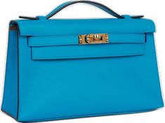 a bright blue purse with gold hardwares on the front and side handles is shown