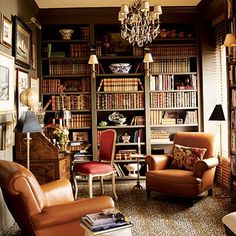 a living room filled with lots of books and furniture