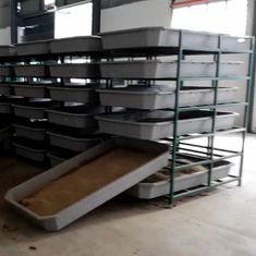 several bins stacked on top of each other in a room with metal racks and shelves