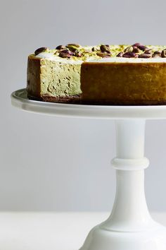 a cake with nuts on top is sitting on a plate