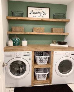 a washer and dryer in a laundry room with shelves above the washer