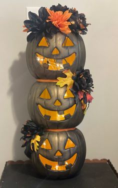 three pumpkins stacked on top of each other