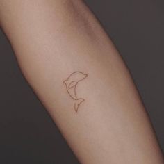 a person's arm with a small tattoo on the left side of their arm