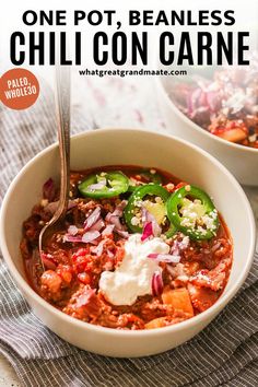 one pot, beanless chili con carne in a white bowl with a spoon