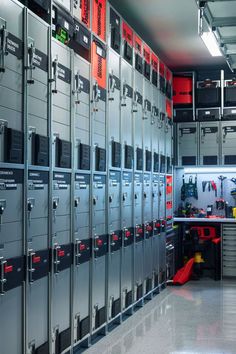 a room filled with lots of metal lockers next to a red light on the wall