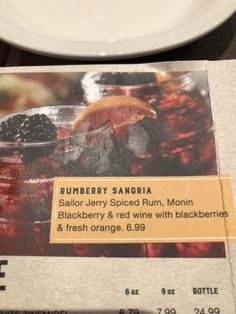 there is a menu for blackberry sangria on the table