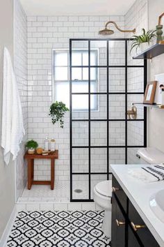 a white bathroom with black and white tiles