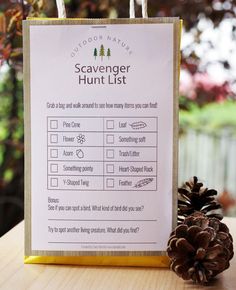 a sign that says scavenger hunt list next to a pine cone on a table