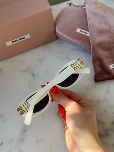 Brand new Miu Miu MU 06ZS 1425S0 Sunglasses in White.Featuring a white acetate frame with dark grey lenses.Gold Miu Miu detailing on temples.Size 54-20-140. 100% authentic and unworn.Made in Italy.Box, case, cloth and paperwork included. Retail price $530. Designer White Polarized Sunglasses, Designer White Sunglasses With Polarized Lenses, Designer Miu Miu Sunglasses For Summer, Miu Miu Designer Sunglasses For Summer, Miu Miu Sunglasses, Men's Eyeglasses, Oval Sunglasses, Grey Lenses, Seychelles