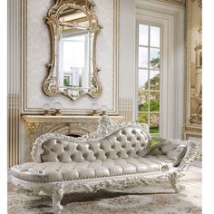 a white couch sitting in front of a mirror