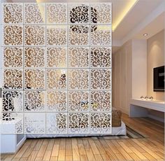 the room divider is made out of white paper and has intricate designs on it