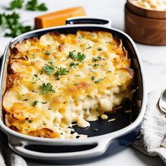 a casserole dish with cheese and parsley