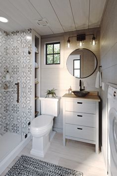 a bathroom with a sink, toilet and washer