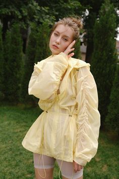 model wears a WISKII semi-formal jacket Fitted Yellow Outerwear For Summer, Fitted Yellow Summer Outerwear, Fitted Windbreaker With Pockets For Spring, Nylon Long Sleeve Windbreaker For Spring, Yellow Long Sleeve Windbreaker For Spring, Fitted Long Sleeve Spring Windbreaker, Fitted Nylon Windbreaker For Spring, Chic Nylon Outerwear For Spring, Chic Spring Nylon Outerwear