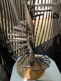 a metal sculpture sitting on top of a white table