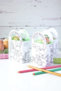 three easter treat bags with colored pencils next to them