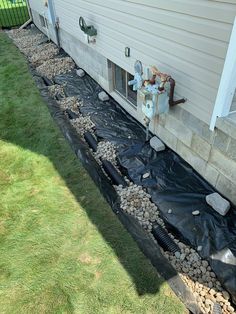 a house that has been gutted and is being worked on by a water main