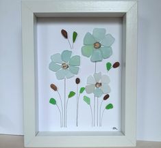 a white frame with some flowers in it