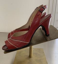 "Very pretty 50's Dark Red & White Leather peep toe sling back heels by \"Troylings\" Seymour Troy size 7N. These have a double row White Diamond pattern across the front and have an adjustable buckle back. They are in excellent vintage condition with general wear consistent with their age and some minor small scuffs. They are in ready to wear condition. Really cute design and great with a Red outfit! The pictures are part of the items description and show condition. Please use the zoom feat Vintage Red Heels For Spring, Vintage Slingback Heels For Spring, Vintage Slingback Pumps For Formal Occasions, Vintage Slingback Pumps With Pointed Toe, Vintage Pointed Toe Slingback Pumps For Summer, Fitted Vintage Heels For Summer, Fitted Vintage Summer Heels, Vintage High Heel Slingback Pumps For Evening, Vintage High Heel Slingback Pumps For Summer