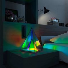 a colorful lamp sitting on top of a bed