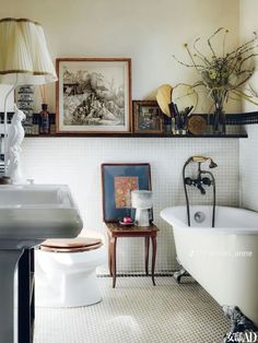 a bathroom with a toilet, sink and bathtub