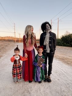 two adults and three children dressed up in costumes