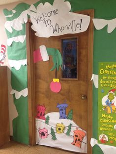 a classroom door decorated with the grin's welcome sign and decorations for christmas time