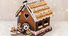 a gingerbread house is decorated with icing and candies for the holiday season